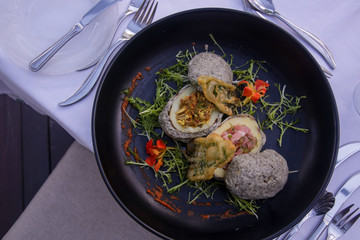 Stir fried potatoes in seaweed crust stuffed with tuna tartar. Exquisite dish. Creative restaurant meal concept.	