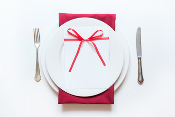 Valentine's day or birthday dinner. Elegance table setting with red decor.