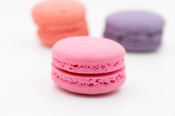 sweet pink and colorful macaroons on white background