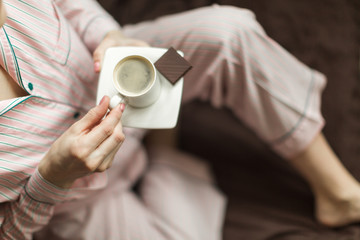 coffee time in bed, girl in pajamas with espresso