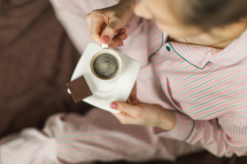 coffee time in bed, girl in pajamas with espresso