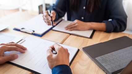 Young students classmates help friend catching up workbook and learning tutoring in a library, education and school concept