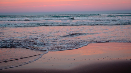 Wild beach with sandy dunes at sunset by the Mediterranean Sea in Valencia Spain