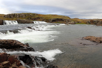Fototapeta na wymiar rough landscape in Iceland with waterfall