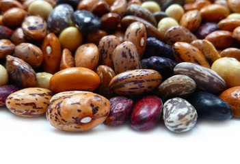 Beans dry mix. Assorted dried beans close up. Variety of protein rich colorful raw dried beans. Multicolored mixed dried beans on white background. Closeup, selective focus