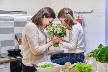 Happy mother and daughter child with spring bouquet