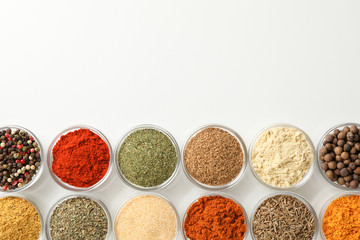 Flat lay. Bowls with different spices on white background, space for text