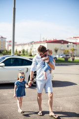 young father and daughters outdoor. Happy family. 