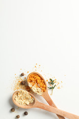 Spoons with turmeric and ginger powder on white background, space for text