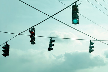 Traffic lights hanging on wires in the air.