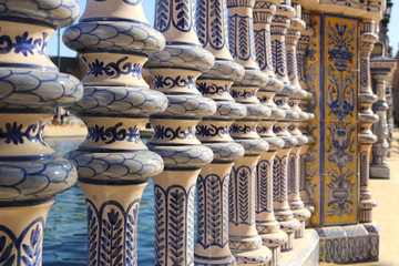 Decorative style of the art of Seville with ornate ceramic railings in blue, white and yellow colors - beautiful postcard background
