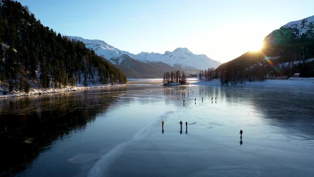 St Moritz Engadin valley Switzerland - winter iced lake skating on ice - aerial view