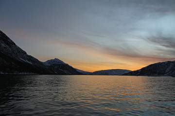 in the fjords of Norway at sunset