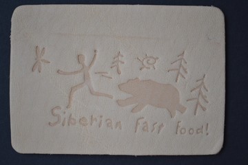 Comic picture on the skin "Siberian fast food", brown bear catches up with man