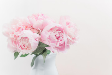 Bouquet of pink peonies in a vase pastel toned.