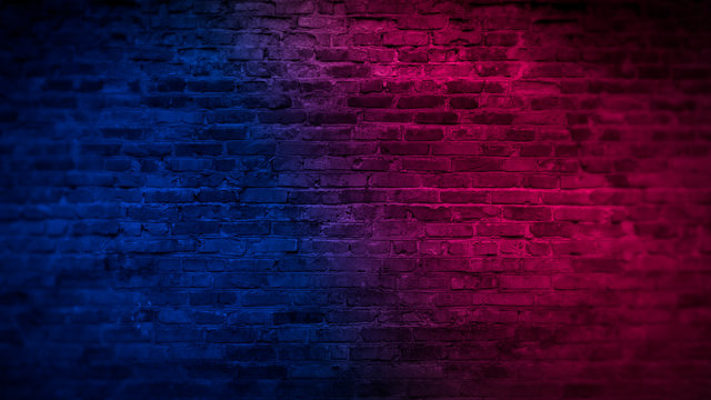 Old brick wall with neon lights. Neon shapes on brick wall background.