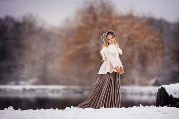 beautiful fairytale photo of a girl in vintage clothes on a winter landscape