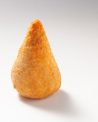 Coxinha is a popular food in Brazil consisting of chopped or shredded chicken meat, covered in dough, molded into a shape resembling a teardrop, battered and fried.