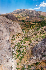 Aerial view of Kahta stream, river, close to Kahta Castle, Kalesi. Valley near the Yeni Kale Fortress in Eski Kahta, hills with a steep slope. Close to Mount Nemrut. Anatolia. Turkey
