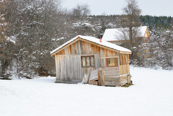 wooden house in the snow
