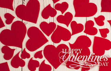 Holiday background for Valentine's Day on a white wooden background which consists of red hearts.