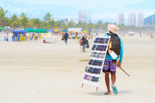 Street vendor selling sunglasses at a brazilian beach. 