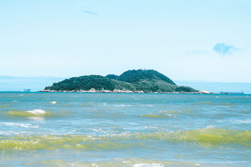 Fototapeta premium Small island in the middle of the sea. Photo of Ilha da Moela island at Guaruja SP, Brazil.