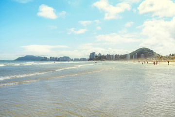 Beautiful sunny day at the beach. Brazilian seacoast, Praia da Enseada beach at Guaruja SP, Brazil.