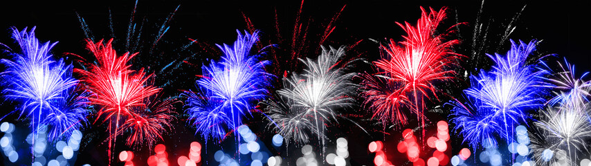 Firework and bokeh lights at night in the colors of the flag from the united states of america...
