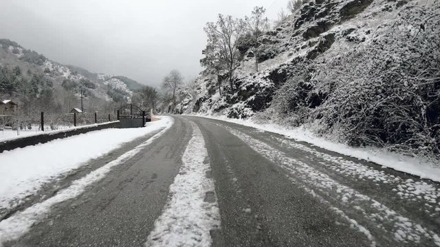 Drive pov on rural road in winter at snow
