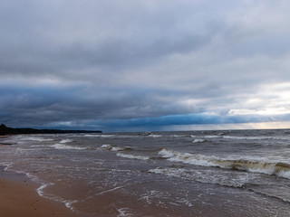 beautiful seascape, dark clouds and white waves