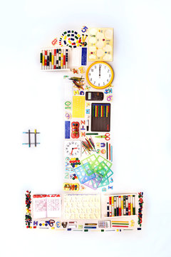 Still life concept school supplies forming number 1