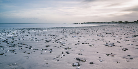 Rocks on tranquil gray beach, Vigsoe, Denmark