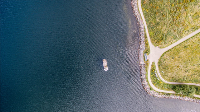 Overhead aerial view of cruise ship on rippled ocean along shore, Frederikssund, Denmark