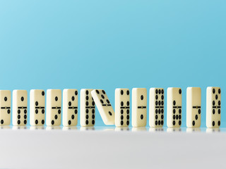 Falling in domino in a row on blue background