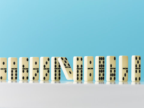 Falling in domino in a row on blue background