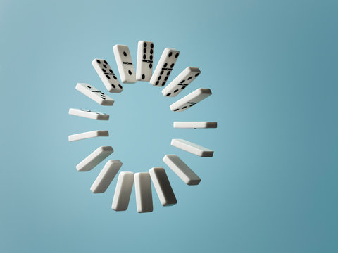 Ring of floating dominoes on blue background