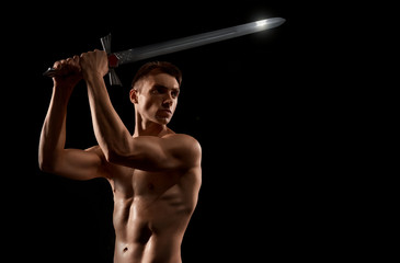 Warrior fight with sword isolated on black.