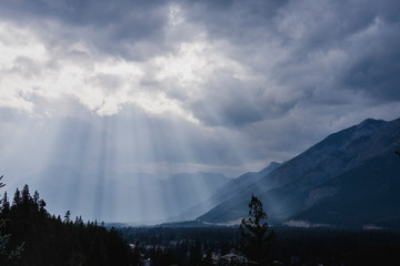 Sunbeams breaking through clouds over idyllic mountains valley, Banff, Alberta, Canada