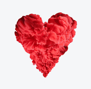 Red ink forming heart-shape on white background