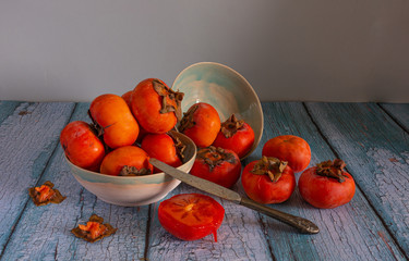 Fototapeta na wymiar Still life with persimmon. Ripe and tasty fruits. Fresh harvest. Vintage.
