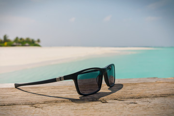 Close up sunglasses on sunny tropical beach