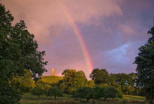 Tranquil rainbow over rural countryside park