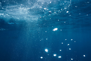 Sunlight and bubbles underwater in blue ocean, Fiji, Pacific Ocean