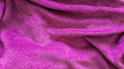 Fototapeta na wymiar Top view of pink blanket with wrinkles