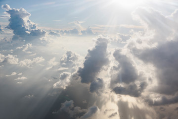 Aerial view sunbeams and fluffy white clouds in ethereal sky