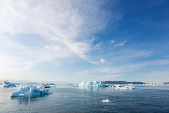 Melting polar ice on sunny blue Atlantic Ocean Greenland