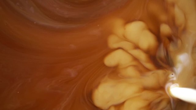 hot coffee and pouring milk cream mixing texture background for drinking concept