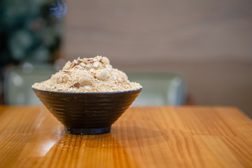 Closeup hojicha Bingsu on tray, Bingsu or Bingsoo, Korean shaved ice dessert with sweet toppings and fruit and varieties with ingredients, popular dessert, using as a background or wallpaper