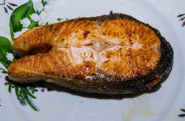cooked salmon steak on a plate, close-up.View from above.